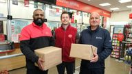 EMBARGOED TO 0001 TUESDAY NOVEMBER 7 EDITORIAL USE ONLY (Right to Left) Neveed, DPD employee, Mark, Post Office employee and Amos, Evri employee, unveil a new partnership between the Post Office and parcel delivery companies, DPD and Evri to launch a new in-branch parcel delivery service, Leighton Buzzard. Issue date: Tuesday November 7, 2023.