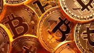 This is a close up photo of several gold plated bitcoins together symbolizing the bit coin market, modern technology, finance, internet, trading, etc.