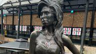 A Star of David neckless on a statue of Amy Winehouse at Camden Market is covered with a sticker of a Palestinian flag.