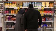 Shoppers walk next to the clubcard price branding inside a branch of a Tesco Extra Supermarket in London, Britain, February 10, 2022. Picture taken February 10, 2022. REUTERS/Paul Childs