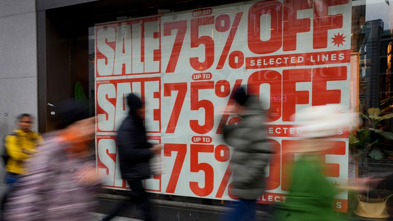 Shoppers pass a window displaying a sale sign on Oxford Street in London, Wednesday, Dec. 20, 2023. Inflation in the U.K. as measured by the consumer prices index has eased back to its lowest level in more than two years. The Office for National Statistics said Wednesday that inflation dropped to 3.9% in the year to November, its lowest level since Sept. 2021, from 4.6% the previous month. (AP Photo/Kirsty Wigglesworth)