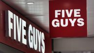 A logo is pictured in front of a fast food chain restaurant Five Guys in Geneva, Switzerland, May 31, 2022. REUTERS/Denis Balibouse