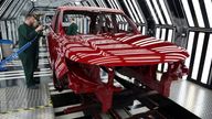 Members of staff check the paintwork on Range Rover bodies as they pass through the paint shop at Jaguar Land Rover’s factory in Solihull, Britain, December 15, 2022. REUTERS/Phil Noble
