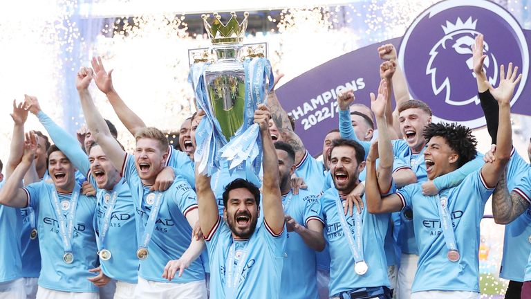 Manchester City's Ilkay Gundogan lifts the trophy as he celebrates with teammates after winning the Premier League.
Pic:Reuters