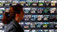 A woman walks past an estate agent's window in Edinburgh, Scotland February 19, 2009.