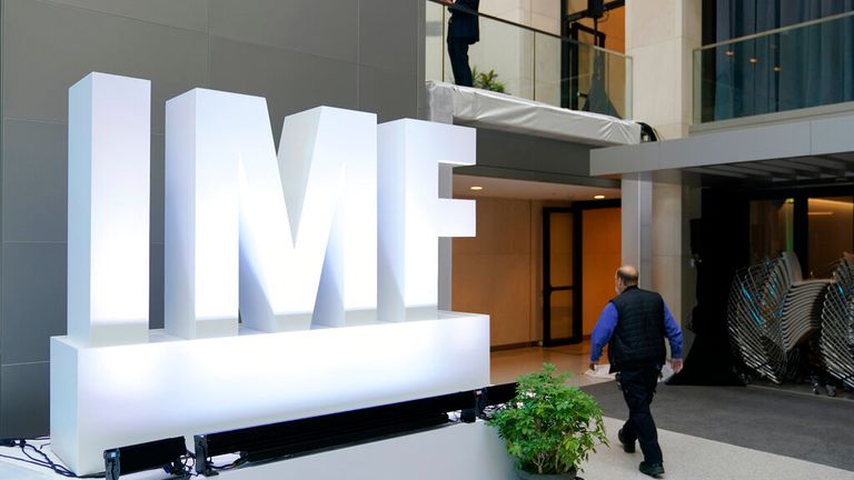 Attendees walk inside an atrium at the 2022 Annual Meetings of the International Monetary Fund and the World Bank Group, Monday, Oct. 10, 2022, in Washington. (AP Photo/Patrick Semansky)