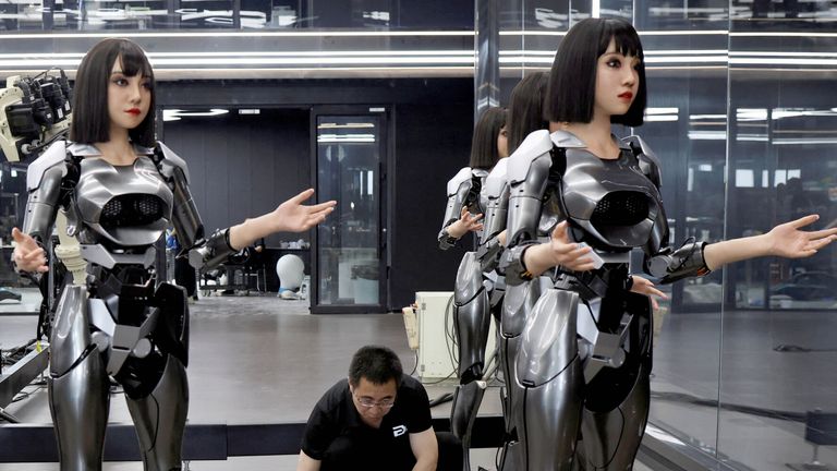 Employees work on humanoid robots at the office of developer Ex-Robots in Dalian, Liaoning province, China.
Pic: Reuters