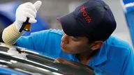 An employee of Toyota Motor Corp. works on the assembly line of Mirai fuel cell vehicle (FCV) at the company's Motomachi plant in Toyota, Aichi prefecture, Japan May 17, 2018. Picture taken May 17, 2018