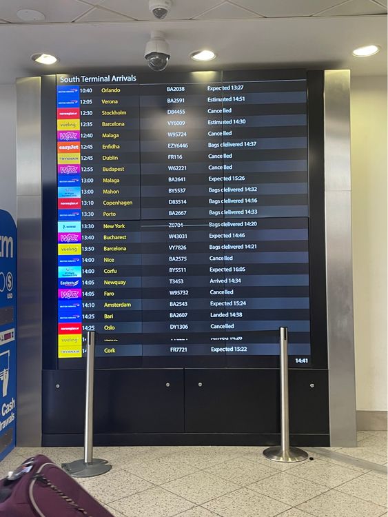 A board at Gatwick Airport shows a mix of fortunes for arriving passengers