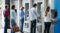 A group of people in a line at an ATM waiting to make a cash withdrawal. Pic: iStock