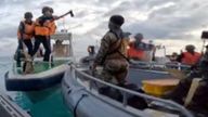 In this handout photo provided by Armed Forces of the Philippines, Chinese Coast Guards hold an axe as they approach Philippine troops on a resupply mission in the Second Thomas Shoal at the disputed South China Sea on June 17, 2024. The Philippine military chief demanded Wednesday that China return several rifles and equipment seized by the Chinese coast guard in a disputed shoal and pay for damage in an assault he likened to an act of piracy in the South China Sea. (Armed Forces of the Philippines via AP)