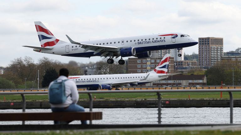 People watch as a British Airways Embraer E190SR takes off from London City Airport in London, Britain, April 11, 2024. REUTERS/Isabel Infantes