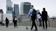 Commuters cross London Bridge in view of the City of London skyline in London, Britain, July 25, 2024. REUTERS/Hollie Adams