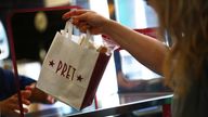 A bag is passed to a customer at Pret a Manger in New Cavendish Street, following the outbreak of the coronavirus disease (COVID-19), London, Britain, June 1, 2020. REUTERS/Hannah McKay