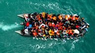 An inflatable dinghy carrying migrants makes its way towards England in the English Channel.
Pic: Reuters