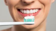 A fil picture of a woman cleaning her teeth. Pic: iStock