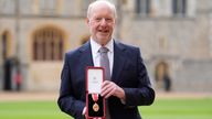 Sir Alan Bates shows off his award outside Windsor Castle. Pic: PA