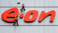 Workers clean the company's logo at an E.On building in Datteln, western Germany.  Pic: AP