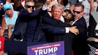 Donald Trump gestures with a bloodied face while he is assisted by U.S. Secret Service personnel.
Pic: Reuters