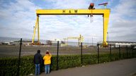 People take pictures of the landmark Samson and Goliath shipbuilding gantry cranes at the Harland & Wolff shipyard in Belfast, Northern Ireland, March 6, 2021. Picture taken March 6, 2021. REUTERS/Clodagh Kilcoyne