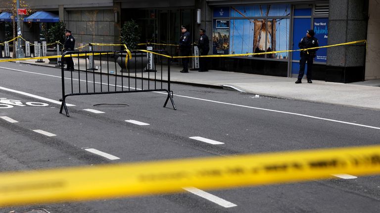 Police officers stand near the scene where the CEO of United Healthcare Brian Thompson was reportedly shot and killed in Midtown Manhattan.
Pic: Reuters
