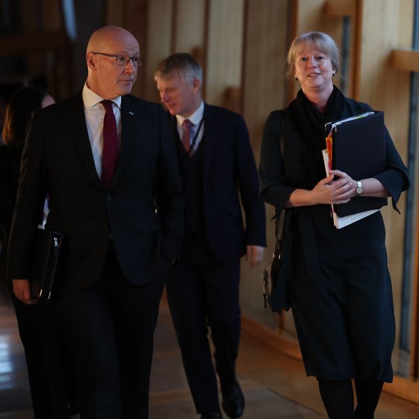 First Minister of Scotland John Swinney, walks with Finance Secretary Shona Robison as she arrives to announce the draft Budget for 2025-26 to MSPs at the Scottish Parliament in Holyrood, Edinburgh. Picture date: Wednesday December 4, 2024.
