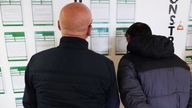 Men looking at vacancies at the Job Centre in Middlesbrough