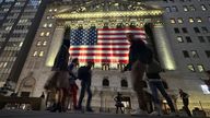 People pass the New York Stock Exchange in New York's Financial District on Tuesday, Nov. 5, 2024. (AP Photo/Peter Morgan)