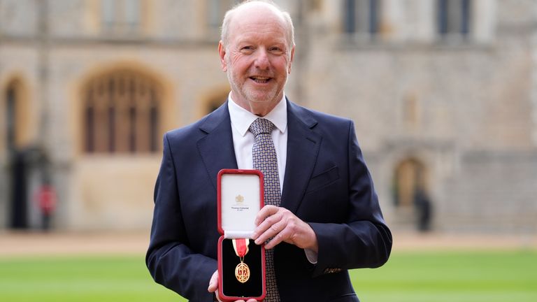 Sir Alan Bates shows off his award outside Windsor Castle. Pic: PA