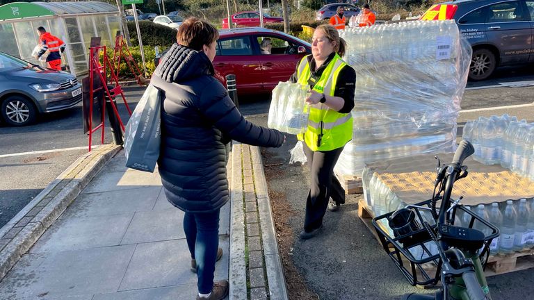 A resident collects water at bottle station at Asda, Totton.
Pic: PA