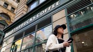 Pedestrians pass a Starbucks in the Financial District of Lower Manhattan, Tuesday, June 13, 2023, in New York. Starbucks is denying union organizers' claims that it banned LGBTQ+ Pride displays in its U.S. stores after Target and other brands experienced backlash. The Seattle coffee giant says there has been no change to its policy and it encourages store leaders to celebrate Pride in June. (AP Photo/John Minchillo)