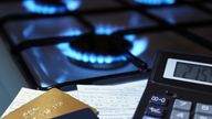 bank cards and a calculator on the background of a burning plate