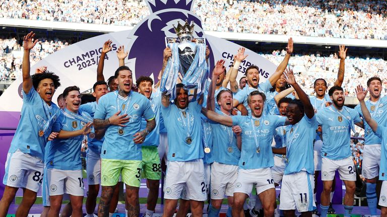 FILE PHOTO: Soccer Football - Premier League - Manchester City v West Ham United - Etihad Stadium, Manchester, Britain - May 19, 2024 Manchester City's Kyle Walker and teammates celebrate with the trophy after winning the Premier League REUTERS/Molly Darlington EDITORIAL USE ONLY. NO USE WITH UNAUTHORIZED AUDIO, VIDEO, DATA, FIXTURE LISTS, CLUB/LEAGUE LOGOS OR 'LIVE' SERVICES. ONLINE IN-MATCH USE LIMITED TO 120 IMAGES, NO VIDEO EMULATION. NO USE IN BETTING, GAMES OR SINGLE CLUB/LEAGUE/PLAYER PUB