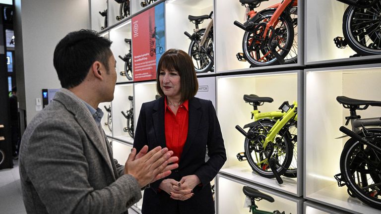 Britain's Chancellor of the Exchequer Rachel Reeves, right, visits a Brompton flagship store in Beijing, Saturday, Jan. 11, 2025. (Jade Gao/Pool Photo via AP)