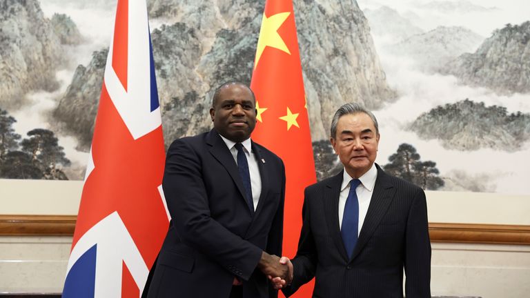 Britain's Foreign Secretary David Lammy and Chinese Foreign Minister Wang Yi shake hands before their meeting at the Diaoyutai State Guesthouse in Beijing. Pic: AP