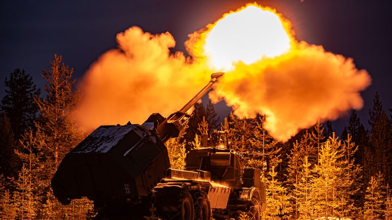 A muzzle flash lights up pine trees as the British Army's new Archer Mobile Howitzer gun fires, as British Army soldiers take part in training near Rovaniemi in the Arctic Circle, Finland. Picture date: Tuesday November 19, 2024.