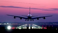 An Emirates Airbus A380 lands during sunrise at London Gatwick Airport in Crawley.
Pic: PA