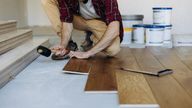 A file image, from iStock, of someone laying a floor