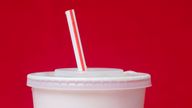 FILE- A large soft drink with a plastic straw from a McDonald's restaurant is shown in Surfside, Fla., May 24, 2018. (AP Photo/Wilfredo Lee, File)