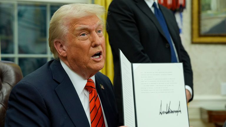 President Donald Trump speaks with reporters as he signs executive orders in the Oval Office at the White House. Pic: PA